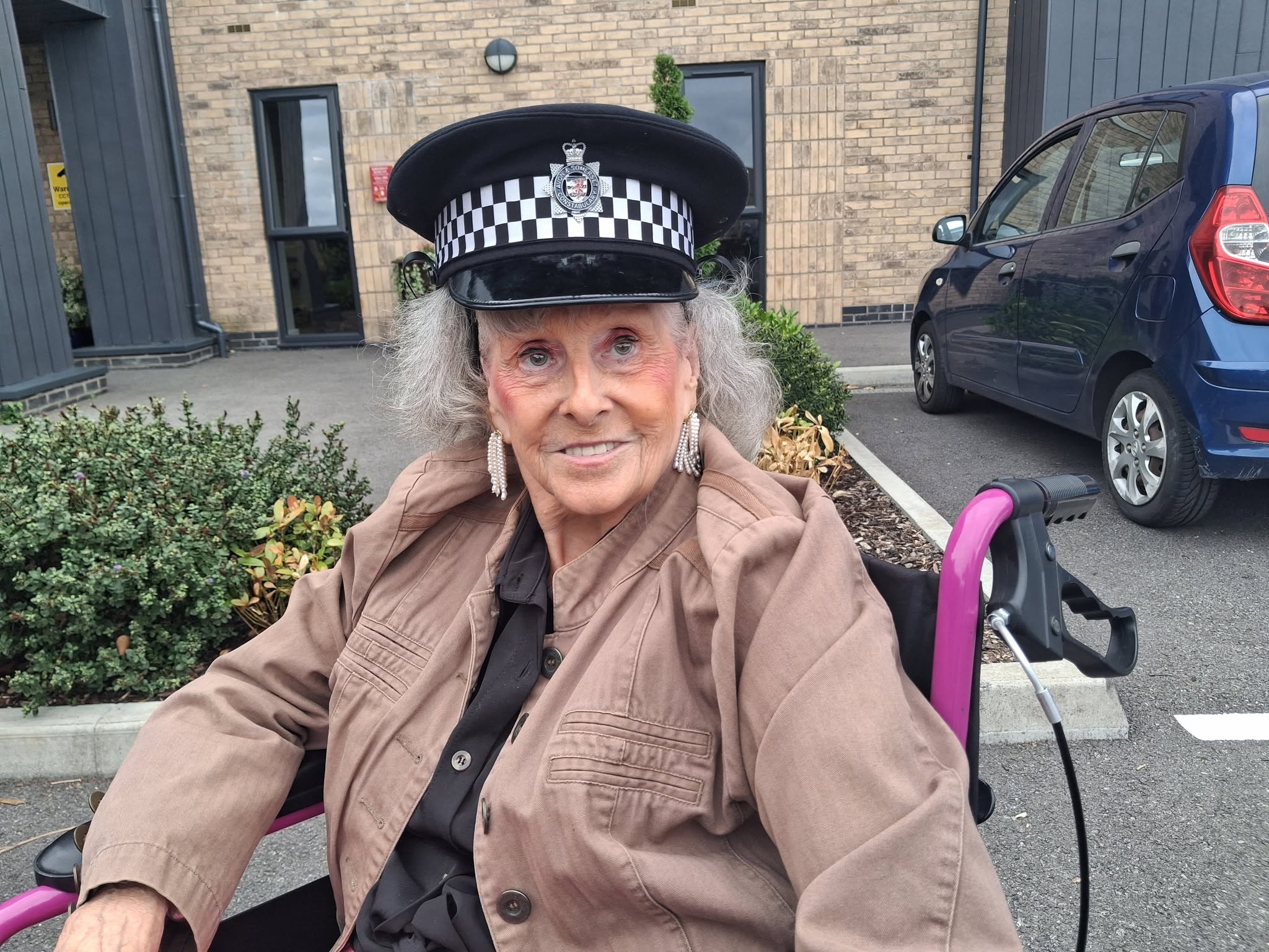 resident wearing police hat