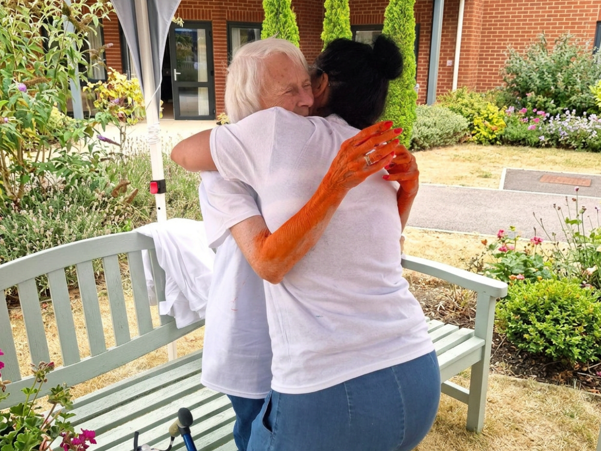 Resident and staff hug