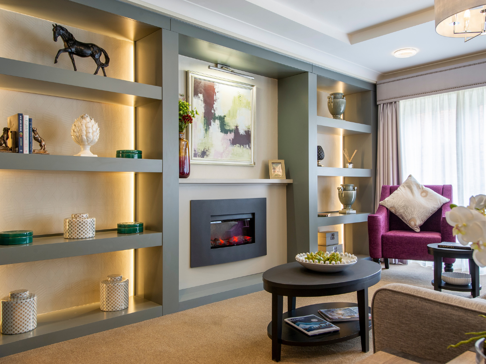 lounge area of care home with sofas and electric fire place