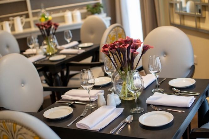 Elegant dining room at Nesbit House Care Home in Orpington with restaurant-style tables for residential and dementia care residents