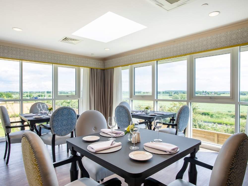 Bright dining area at Edwalton Manor Care Home in Nottingham with countryside views, restaurant-style tables and sociable dining spaces for daily life
