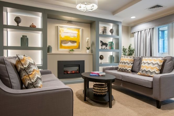 Comfortable resident lounge at Cofton Park Manor Care Home in Birmingham with soft seating, fireplace and relaxing communal spaces