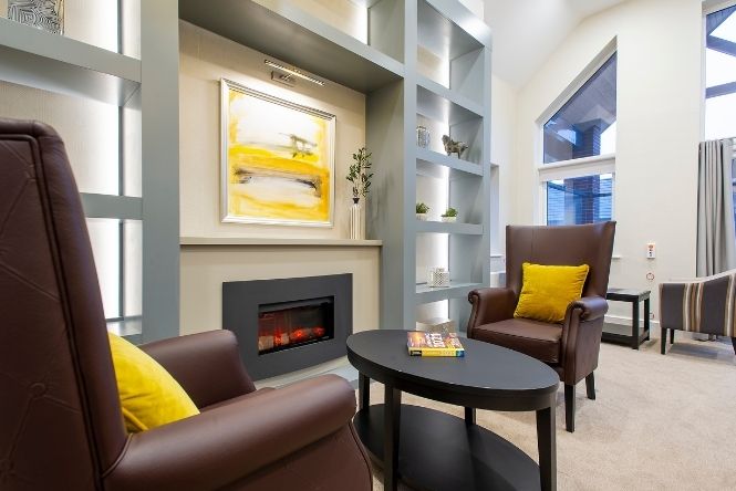 Lounge area with leather chairs and an electric fire