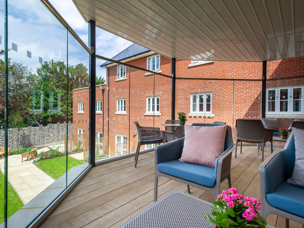 balcony area overlooking well kept lawn and flower borders