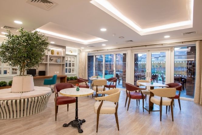 Bright bistro and café space at Cofton Park Manor Care Home in Birmingham with comfortable seating and garden access for residents and families