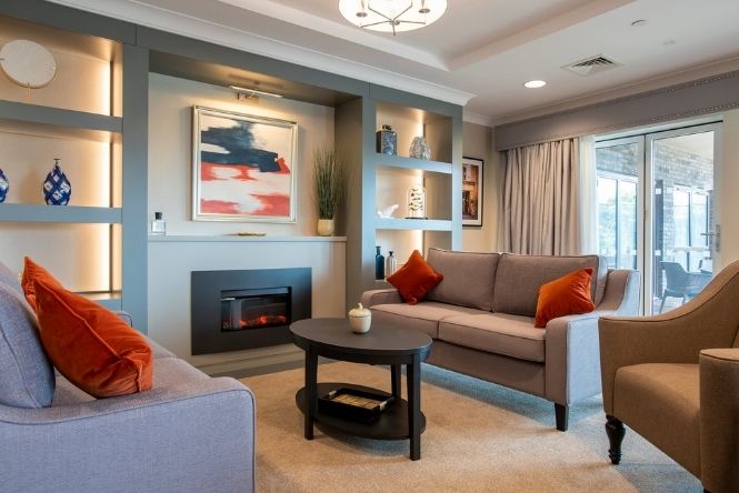 Comfortable lounge with fireplace at Brookwater House
