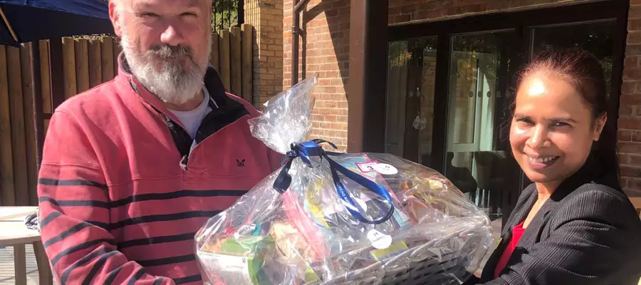 Delighted Stephen picks up hamper prize at Dorking Manor